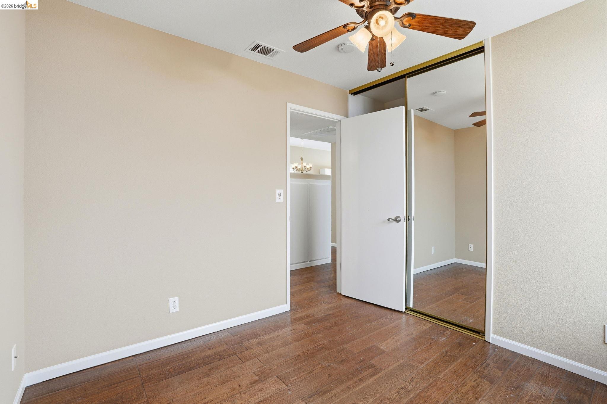 4465 Fall Lane Oakley, CA 94561 - Photo 10 of 26 an empty room with wooden floor fan and windows