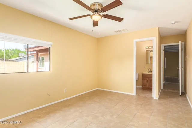 a view of a room with a ceiling fan and a window