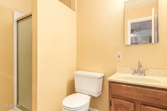a white toilet sitting next to a bathroom sink