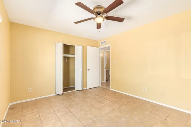a view of a big room with a ceiling fan