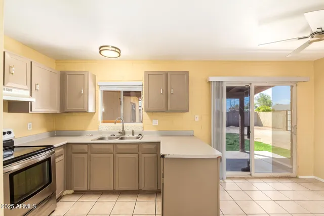 a kitchen with a sink cabinets and window