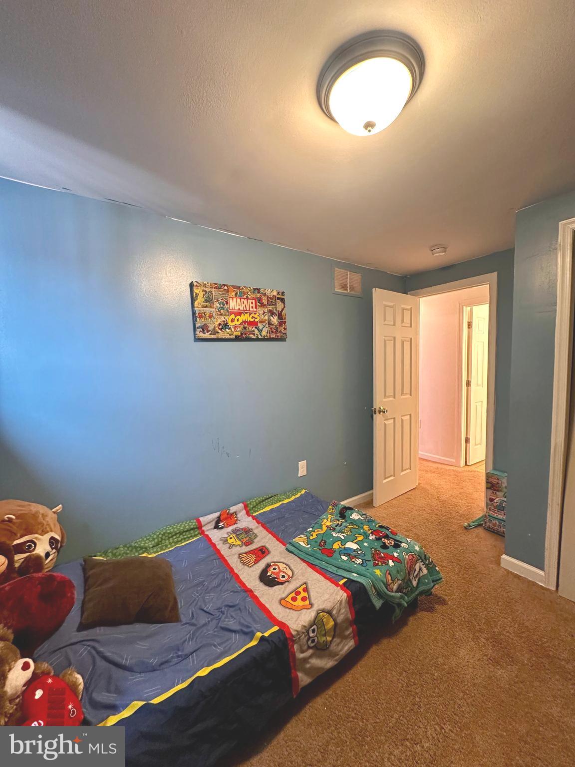 528 Randolph Street Camden, NJ 08105 - Photo 12 of 17 a bed sitting in a bedroom next to a window