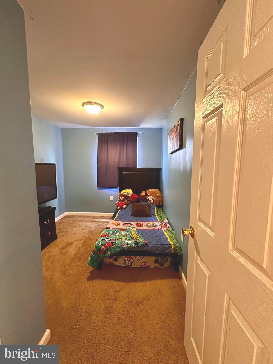 528 Randolph Street Camden, NJ 08105 - Photo 13 of 17 a bed room with a bed and a tv