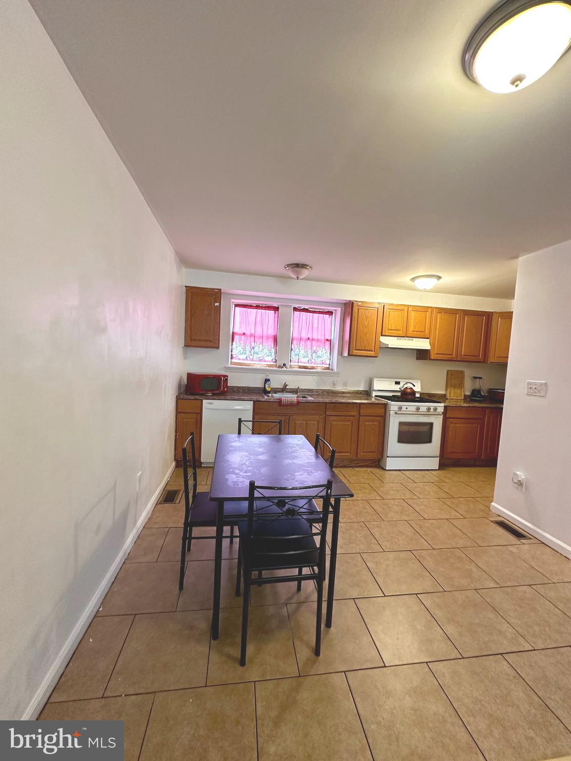 528 Randolph Street Camden, NJ 08105 - Photo 4 of 17 a room with furniture a table and chairs