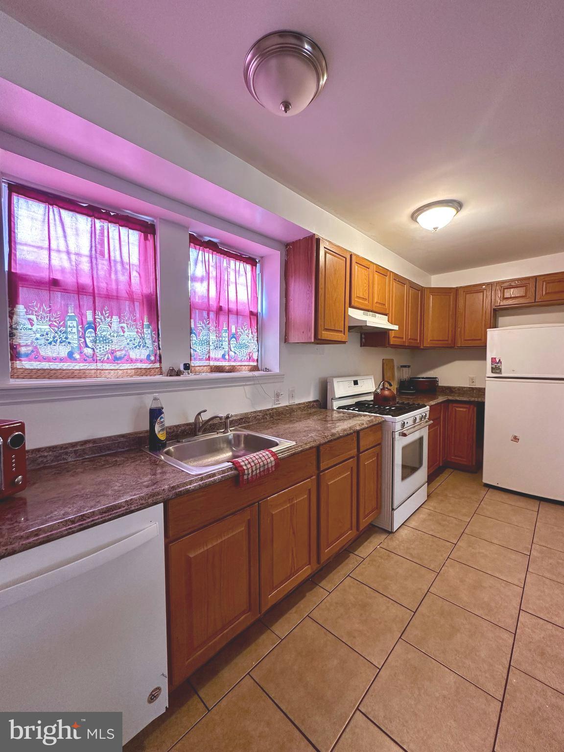 528 Randolph Street Camden, NJ 08105 - Photo 5 of 17 a kitchen with a sink a counter top space cabinets and stainless steel appliances