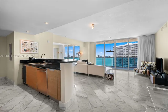 a kitchen with a sink and a stove top oven with wooden floor