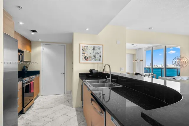 a kitchen with stainless steel appliances granite countertop a stove and a refrigerator