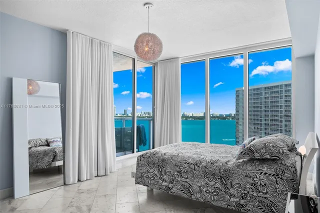 a bedroom with a bed and a chandelier