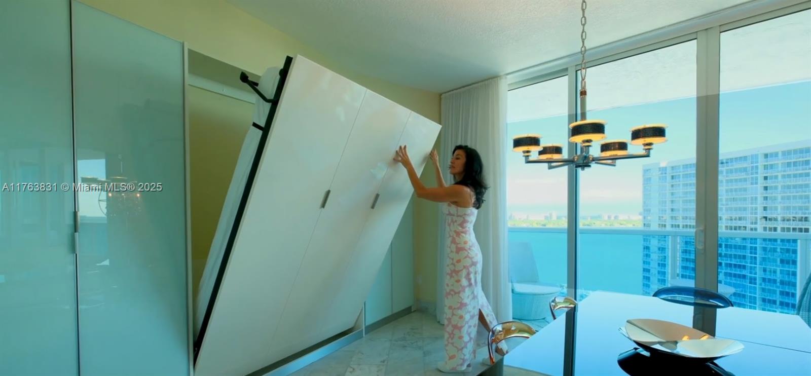 1881 79th Street Causeway, Unit 1906 North Bay Village, FL 33141 - Photo 7 of 39 open-concept guest bedroom designed to maximize light and water views—perfect as a bedroom, office, or flex space. Dining table can be remove to put back the original space for the second guest bedroom