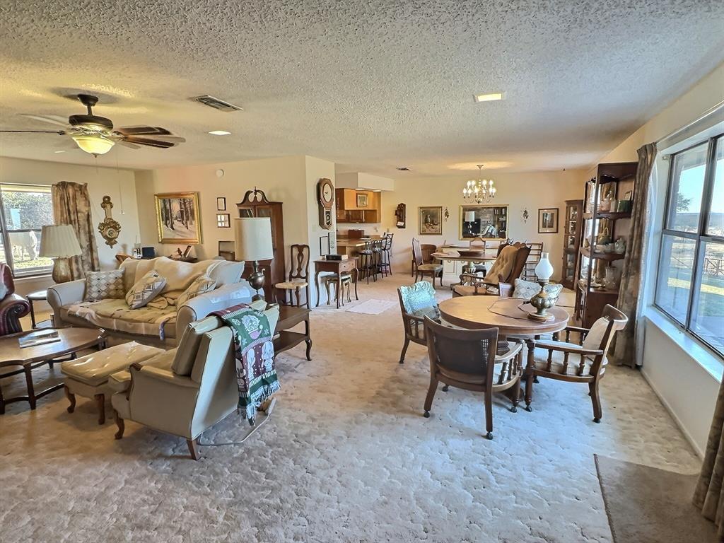 3718 Highway 36 Rising Star, TX 76471 - Photo 11 of 40 a living room with lots of furniture a rug and a chandelier