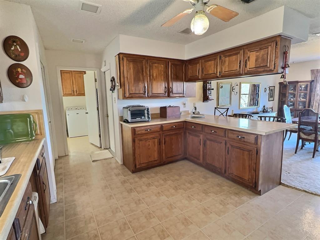 3718 Highway 36 Rising Star, TX 76471 - Photo 16 of 40 a kitchen with a sink refrigerator and cabinets