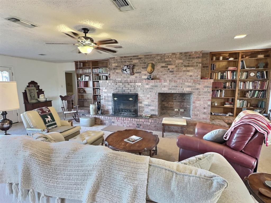 3718 Highway 36 Rising Star, TX 76471 - Photo 9 of 40 a living room with furniture and a fireplace