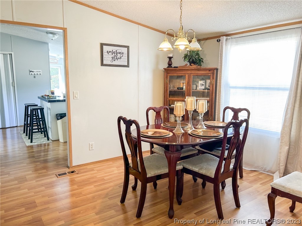 259 Burch Road Lumberton, NC 28360 - Photo 11 of 13 a view of a dining room with furniture window and wooden floor