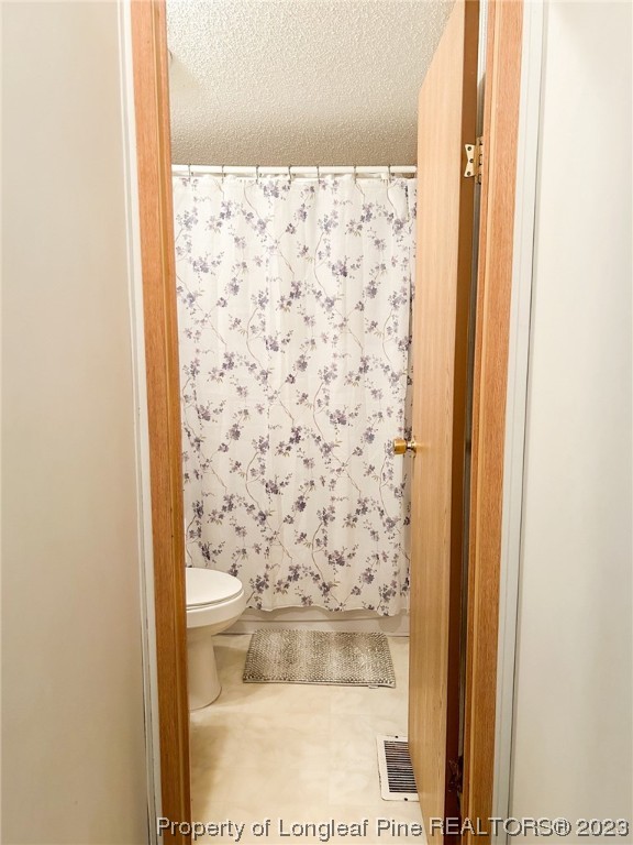 259 Burch Road Lumberton, NC 28360 - Photo 13 of 13 a bathroom with a shower curtain