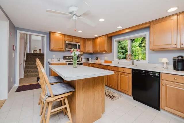 a kitchen with a stove a sink and a refrigerator