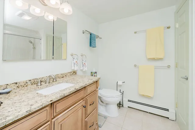 a bathroom with a granite countertop sink toilet and shower