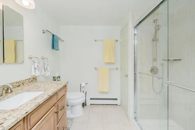 a bathroom with a sink toilet and shower