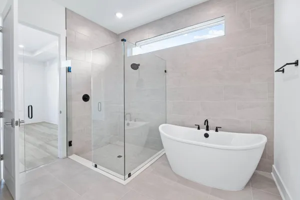 a white bath tub sitting next to a bathroom