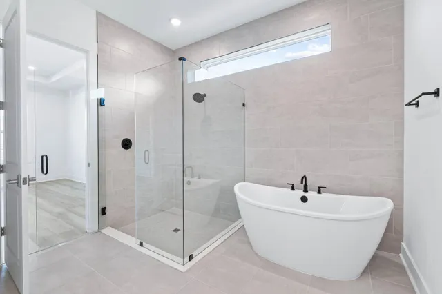 a white bath tub sitting next to a bathroom