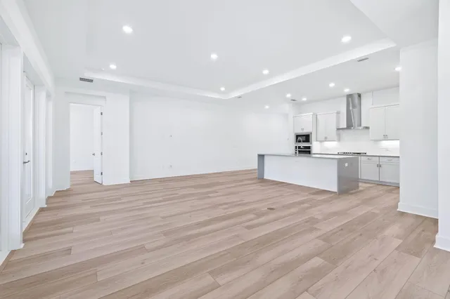 a view of kitchen with wooden floor and electronic appliances