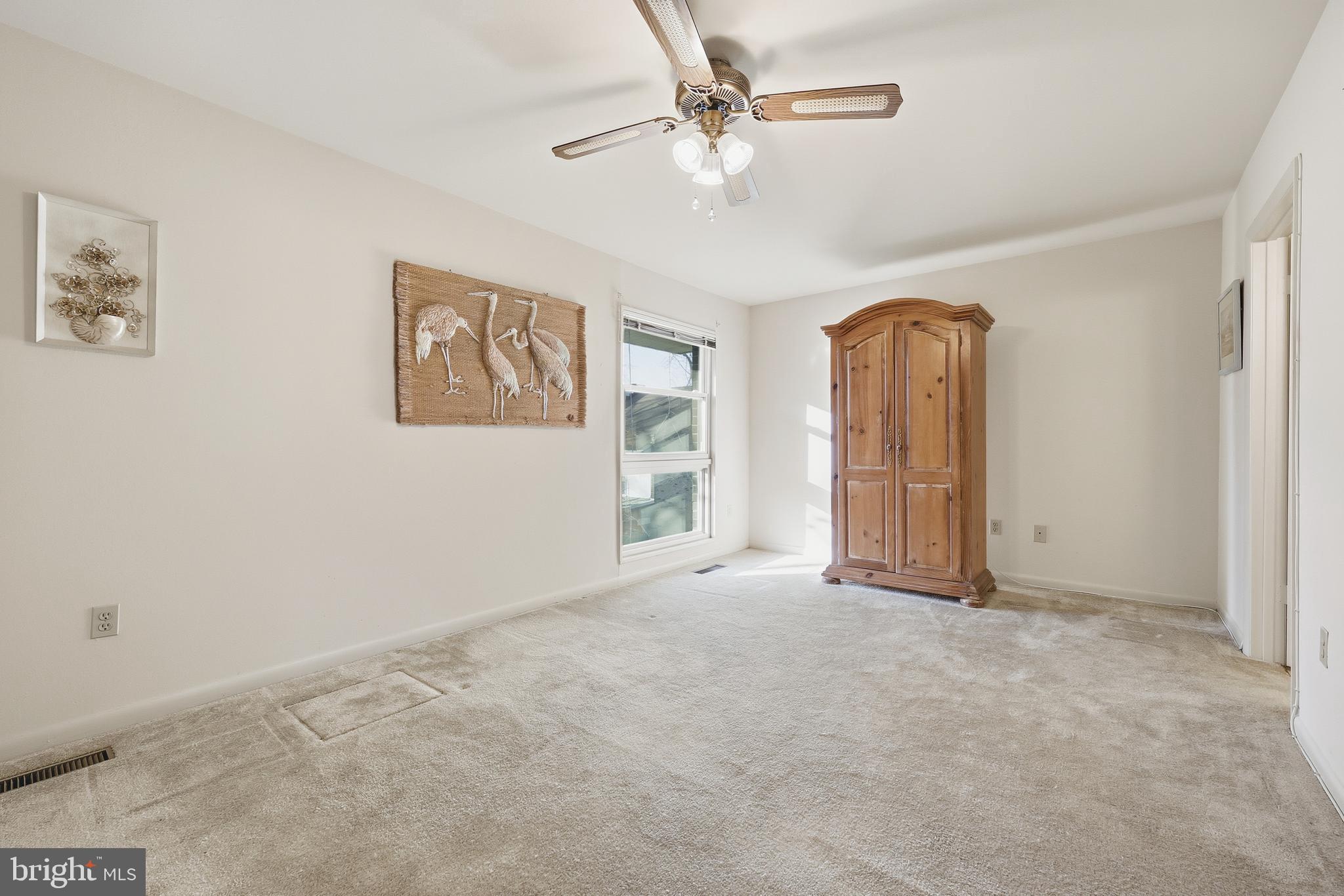 3345 North Leisure World Boulevard, Unit 96J Silver Spring, MD 20906 - Photo 14 of 50 an empty room with windows and fan