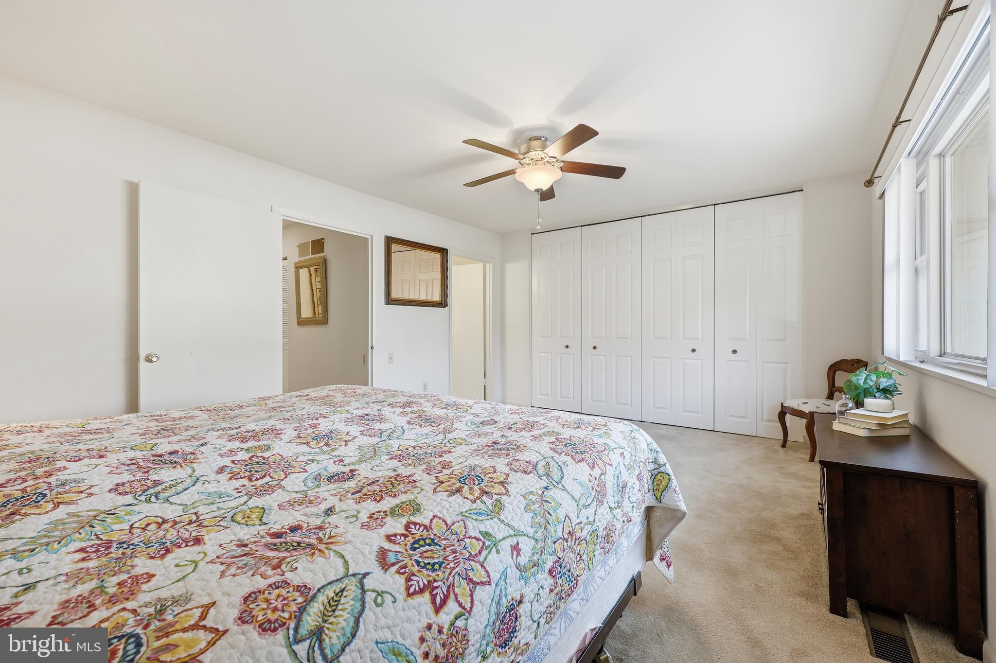 3345 North Leisure World Boulevard, Unit 96J Silver Spring, MD 20906 - Photo 21 of 50 a bedroom with a bed and a chandelier