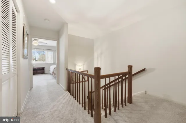 a view of a hallway with a livingroom and furniture
