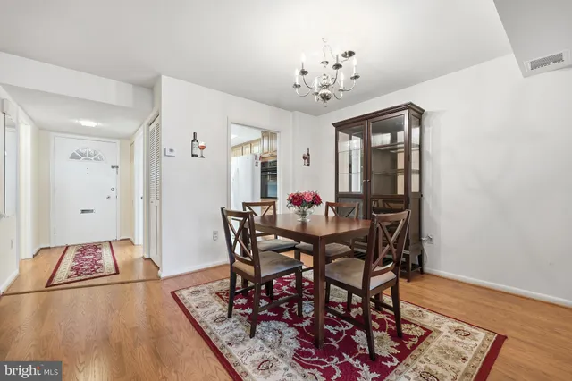 a view of a dining room with furniture and chandelier