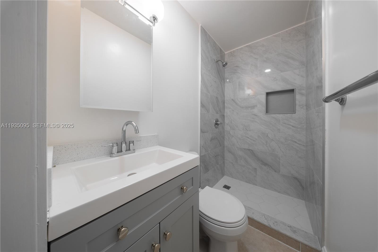 3219 Southwest 141st Avenue, Unit 1 Miami, FL 33175 - Photo 9 of 17 a bathroom with a sink a toilet and shower