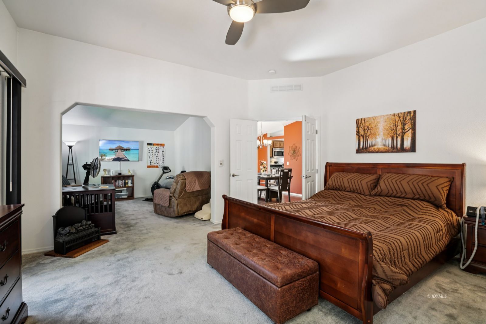 25001 Rim Rock Road Idyllwild, CA 92549 - Photo 27 of 50 a spacious bedroom with a bed a couch and a chandelier