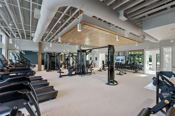 a room with gym equipment and a large window
