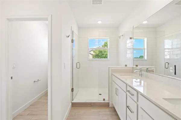 a bathroom with a granite countertop sink mirror and a bathtub