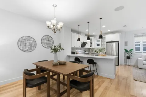 a view of a dining room with furniture and chandelier