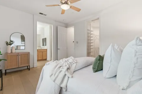 a bathroom with a tub a double vanity sink and a mirror