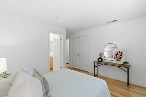 a bathroom with a sink toilet a large mirror and shower