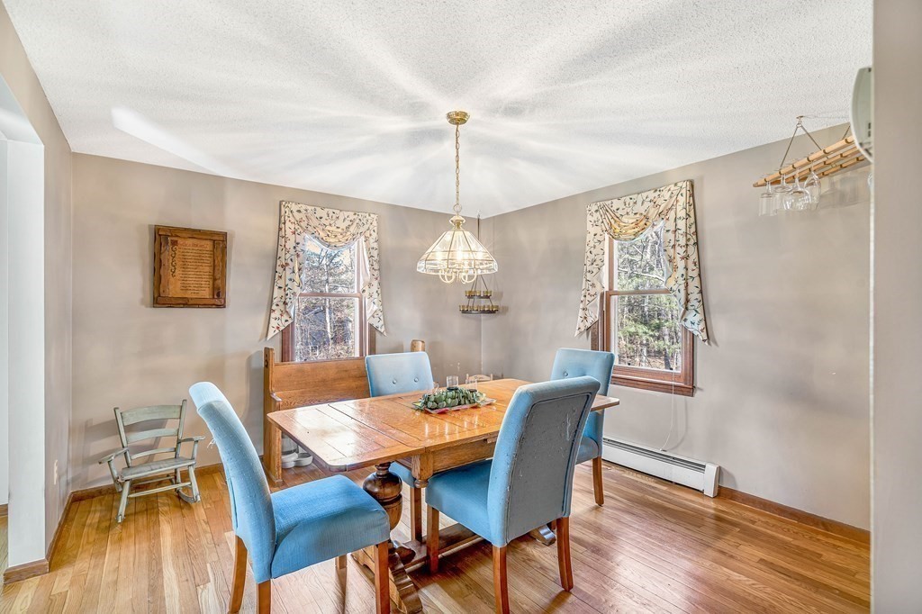 36 Autumn Road Lunenburg, MA 01462 - Photo 10 of 29 a dining room with furniture a chandelier and wooden floor