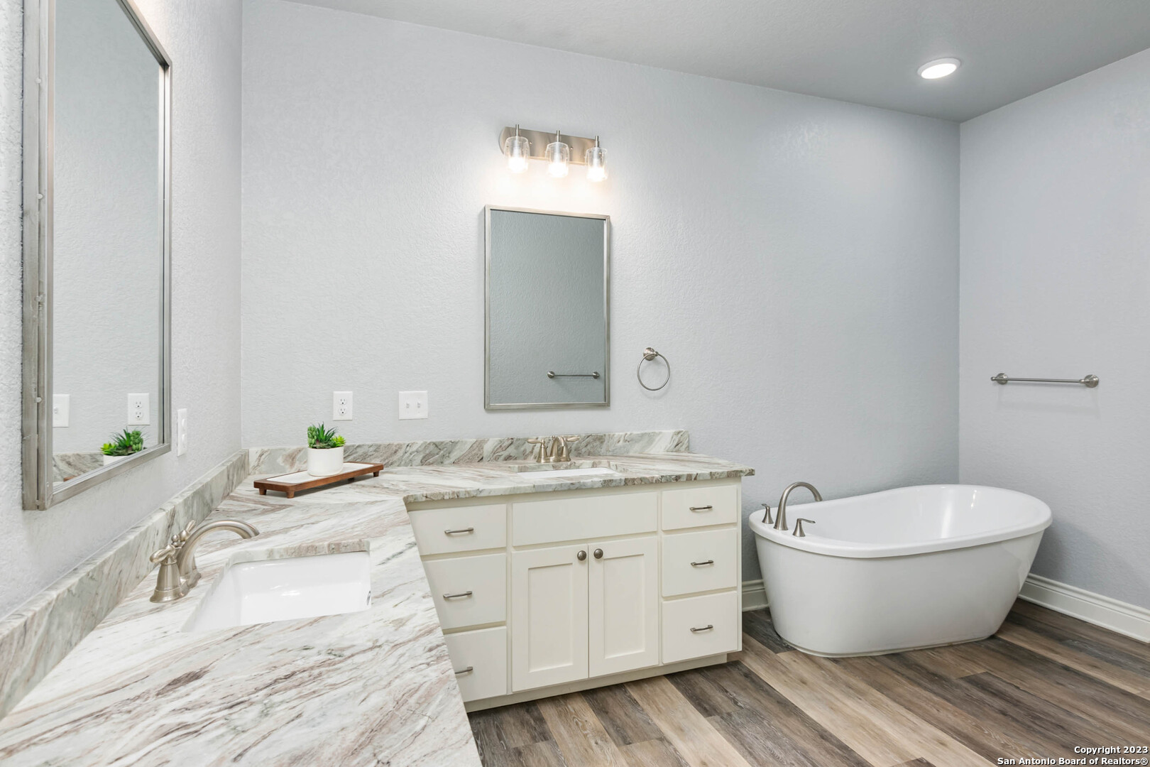230 Club View West Seguin, TX 78155 - Photo 13 of 24 a spacious bathroom with a granite countertop toilet a sink and a mirror