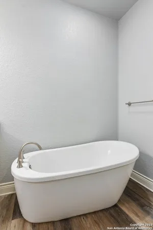 a white tub sitting next to a white sink