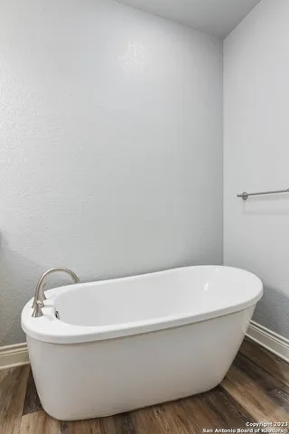 a white tub sitting next to a white sink