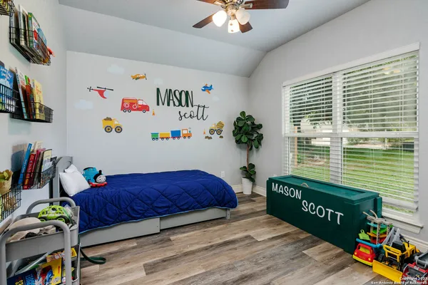 a bedroom with a bed and a book shelf