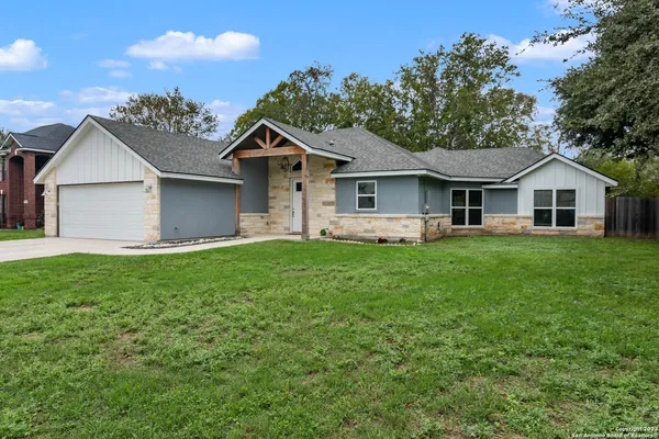 a front view of house with yard and green space