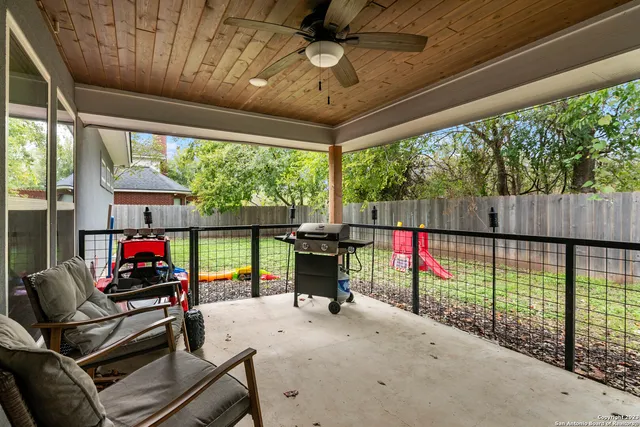 a view of a patio with table and chairs