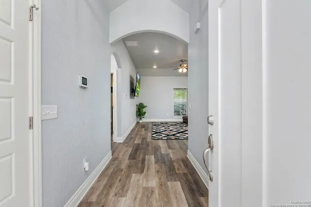 a view of a hallway and wooden floor