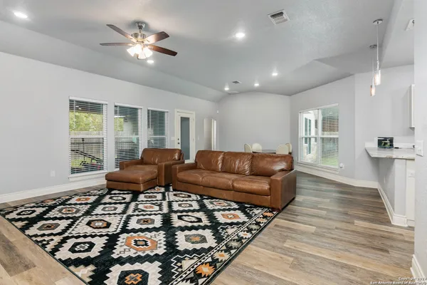 a living room with furniture and a chandelier