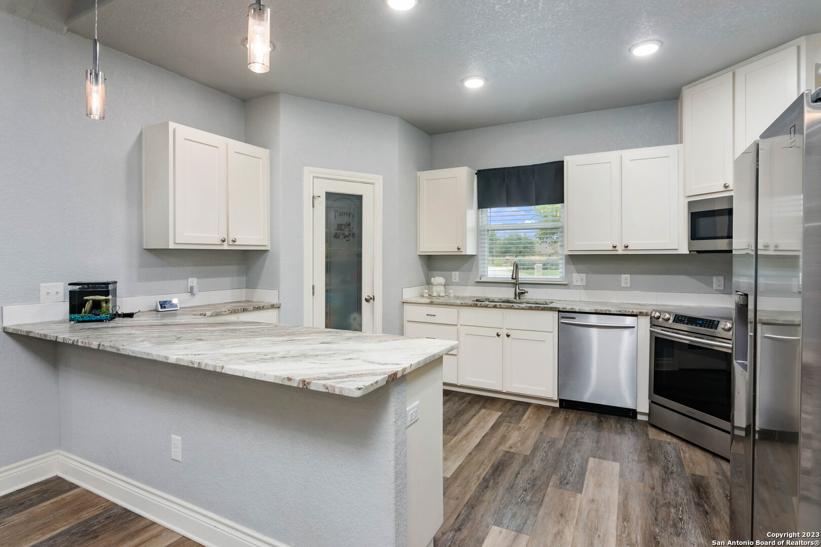230 Club View West Seguin, TX 78155 - Photo 8 of 24 a kitchen with stainless steel appliances granite countertop a sink stove and refrigerator