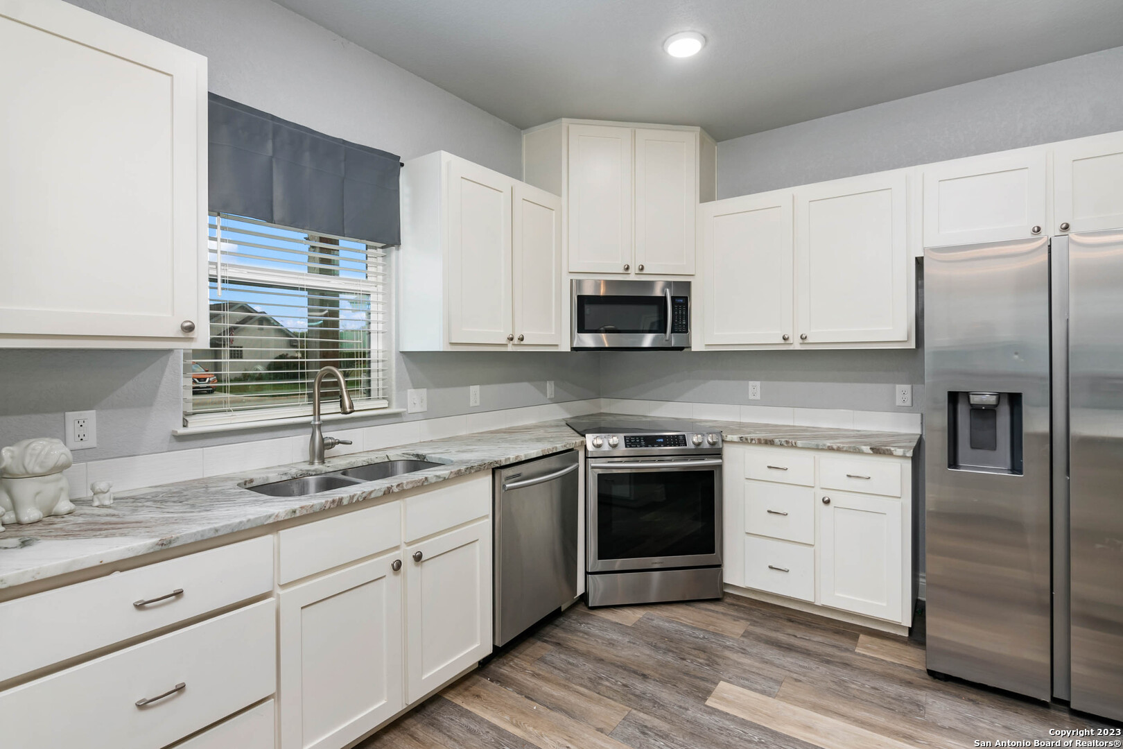 230 Club View West Seguin, TX 78155 - Photo 10 of 24 a kitchen with stainless steel appliances granite countertop a refrigerator sink and stove