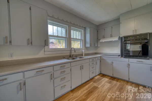a kitchen with sink cabinets and window