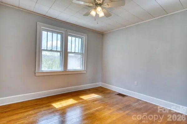 a view of a room with window and wooden floor
