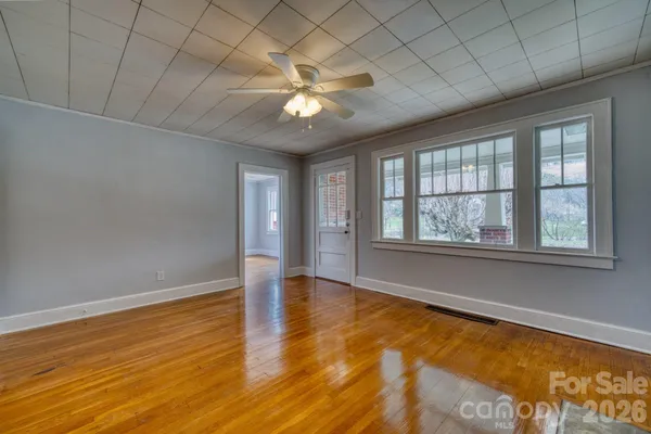 wooden floor in an empty room with a window