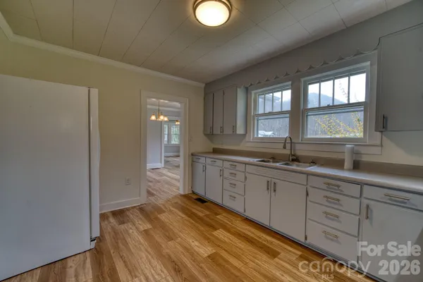 a spacious bathroom with a granite countertop sink and a window